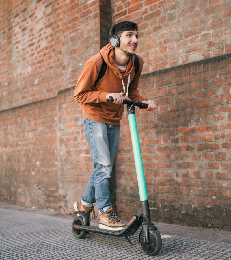 young-man-driving-electric-scooter--e1632797455870.jpg