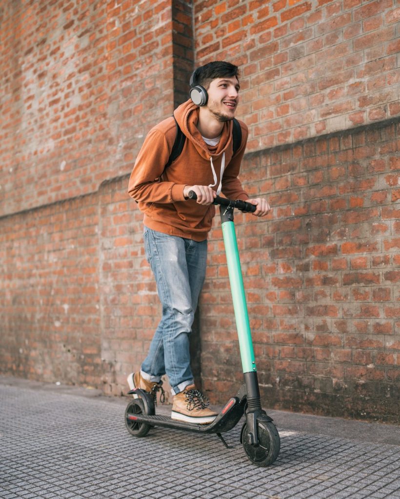 young-man-driving-electric-scooter--e1632797455870.jpg